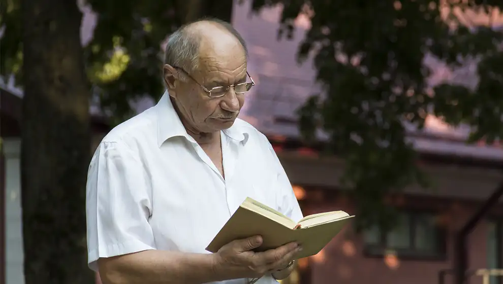 An older man reading a book