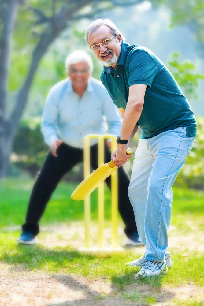 Old man playing cricket