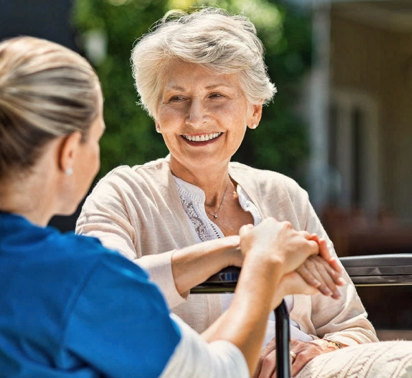 Two women sitting at a table talking to each other